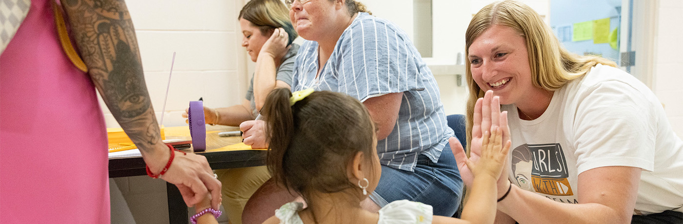 student highfiving teacher